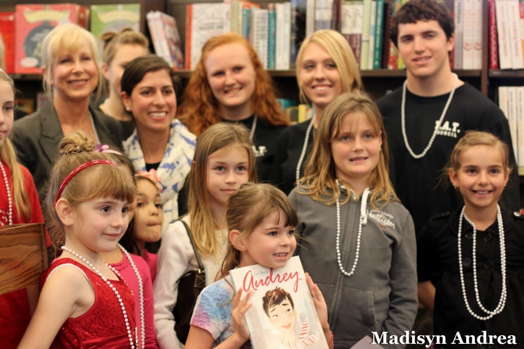 A happy  moment was captured by 15-year-old Gulf Coast High School student photographer, Madisyn Andrea, at the Kids Celebrate Reading Book Fair hosted by K is for Kids teen leaders in 2011. Children gathered around Florida's First Lady Ann Scott and "All About Audrey" children's book author Margaret Cardillo while the student leaders (now seniors in college) who hosted and organized the event surround them.  The children met the guest author and then became young authors themselves, with each writing a page in a commemorative book published by K is for Kids. 