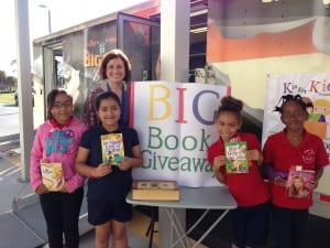 Golden Terrace Intermediate's Meda Specialist Tiffany Weeks with students at K is for Kids' Big Book Giveaway. Photo by Brigitte Papita, K is for Kids' student spokesperson and FGCU intern!