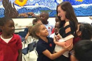 1 Youngsters give big hugs at book giveaway by Operation Outreach