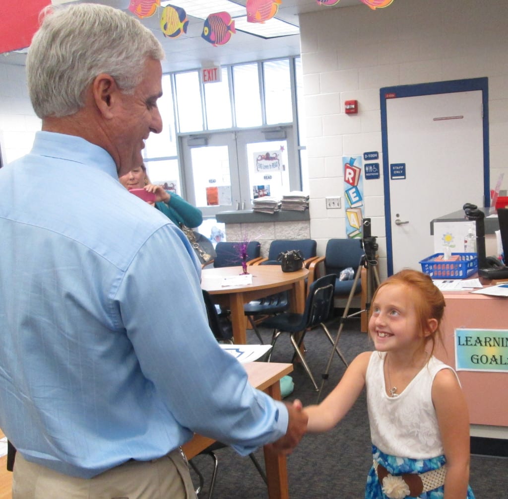 Everglades City School Principal Bob Spano congratulates one of the school's youngest top readers. Young honorees had the opportunity to select new books to take home through K is for Kids' Top Reader Book Awards.