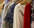 Outfits on clothing racks backstage - 1