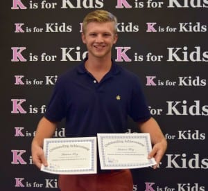 Hadrien Roy receives certificates for his leadership skills and hard work as a Student Leader for K is for Kids. Photo by Ann Alvarez, student at Gulf Coast High School.